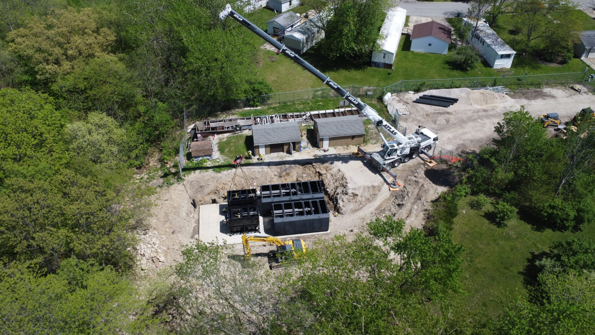 Aerial view of residential construction site with heavy machinery.