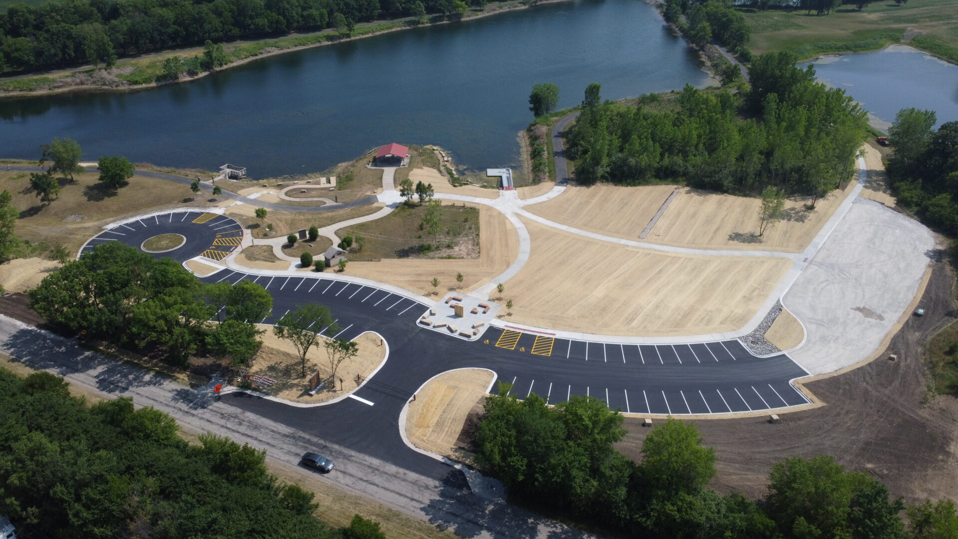 Aerial view of a newly constructed park with parking lot.