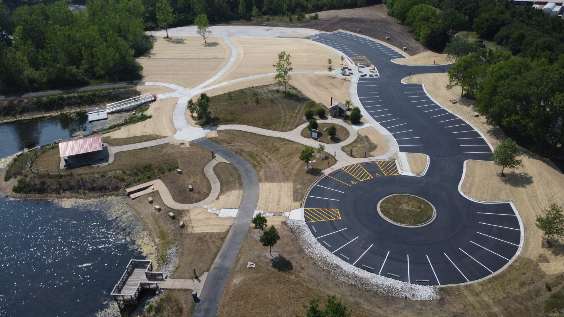Aerial view of scenic park with roads and parking lot.
