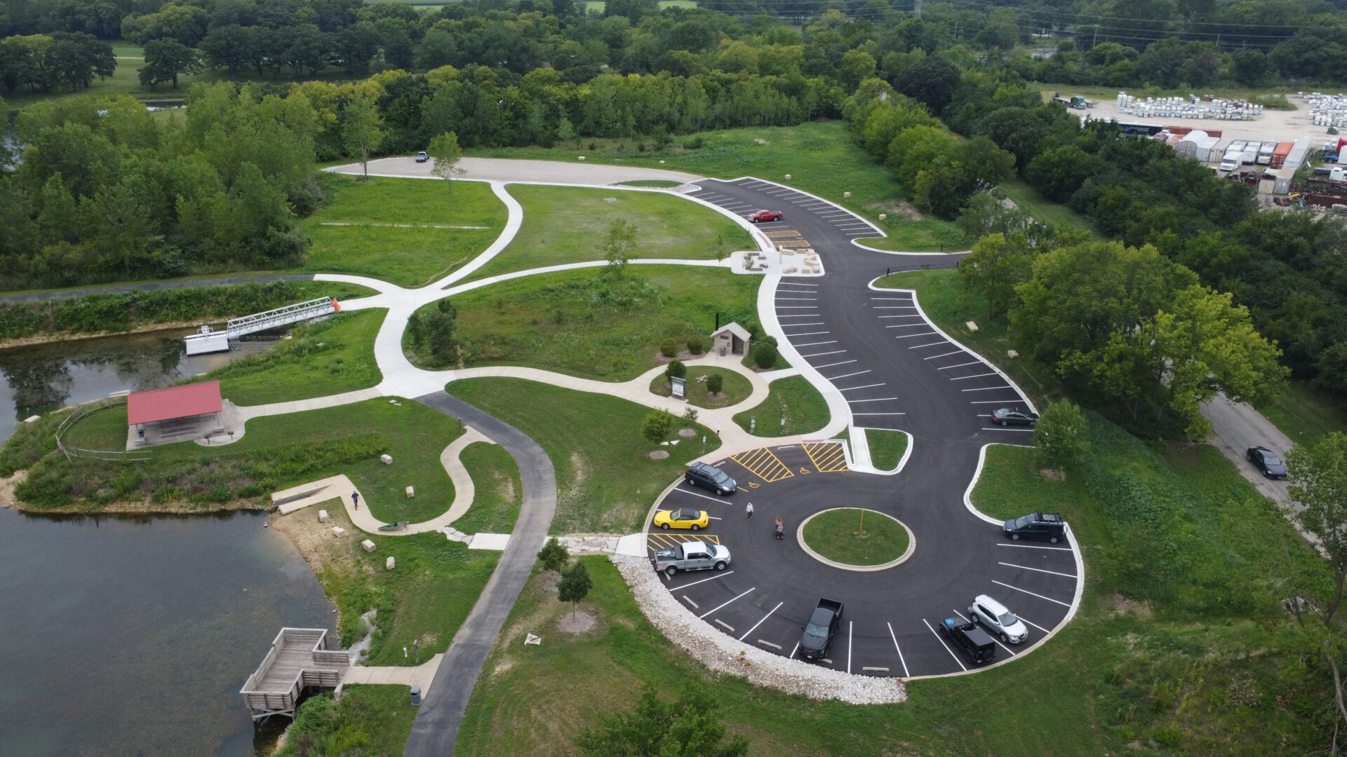 Aerial view of scenic park with winding pathways and lake.
